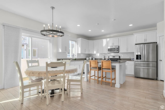 4927 W Yellow Topaz Dr, Herriman, UT 84096 - dining area featuring light wood-style floors, a chandelier, and recessed lighting