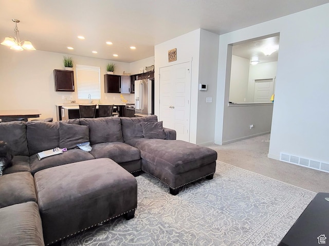 6583 W Annie Lee Way, West Jordan, UT 84081 - living room with recessed lighting, light colored carpet, a chandelier, baseboards, and visible vents