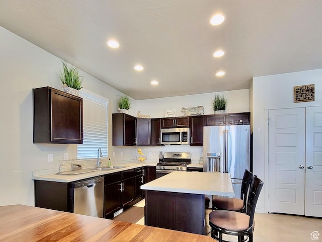 6583 W Annie Lee Way, West Jordan, UT 84081 - kitchen featuring recessed lighting, a sink, dark brown cabinets, and stainless steel appliances