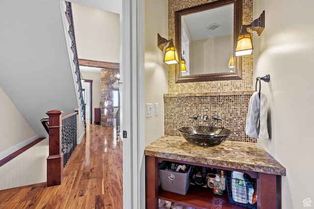 267 E Lucky Star Way, Farmington, UT 84025 - bathroom featuring wood finished floors, decorative backsplash, baseboards, and vanity