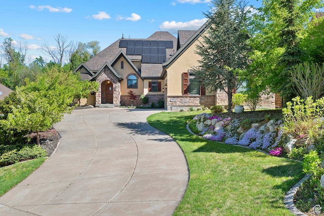 267 E Lucky Star Way, Farmington, UT 84025 - view of front facade with stucco siding, stone siding, solar panels, and a front lawn