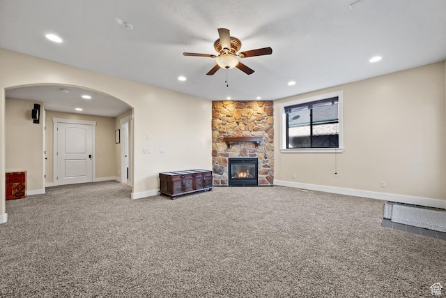 267 E Lucky Star Way, Farmington, UT 84025 - unfurnished living room featuring ceiling fan, arched walkways, carpet, a stone fireplace, and recessed lighting