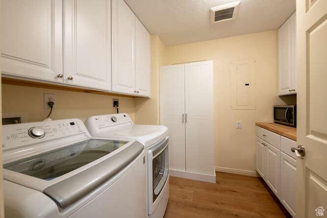 560 E S Temple N Pl 102, Salt Lake City, UT 84102 - laundry room with separate washer and dryer, light wood finished floors, cabinet space, and baseboards