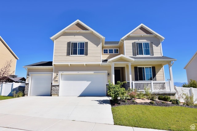 2292 N Elderberry Dr W, Saratoga Springs, UT 84045 - view of front of home featuring a porch, fence, driveway, and a garage