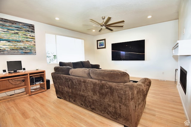 2292 N Elderberry Dr W, Saratoga Springs, UT 84045 - living room featuring light wood-style flooring, a fireplace, ceiling fan, and recessed lighting