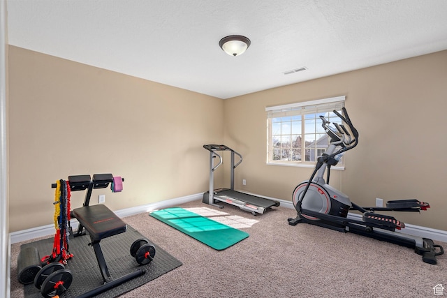 workout area featuring carpet flooring and baseboards