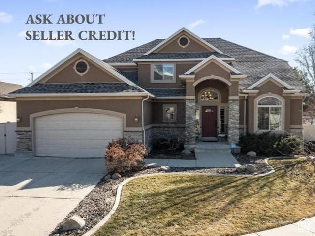 view of front of house featuring stucco siding, stone siding, driveway, a garage, and a front lawn