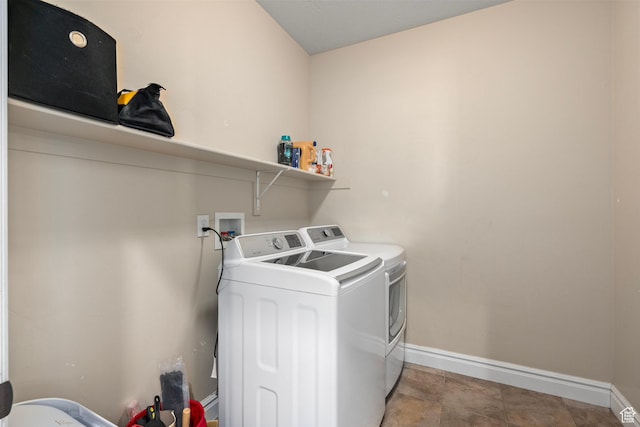 laundry room featuring independent washer and dryer and baseboards