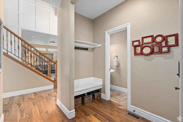 mudroom featuring wood finished floors and baseboards