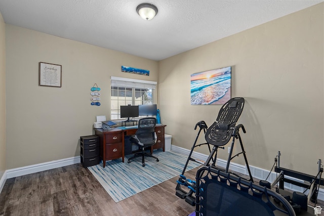 home office with wood finished floors, baseboards, and a textured ceiling