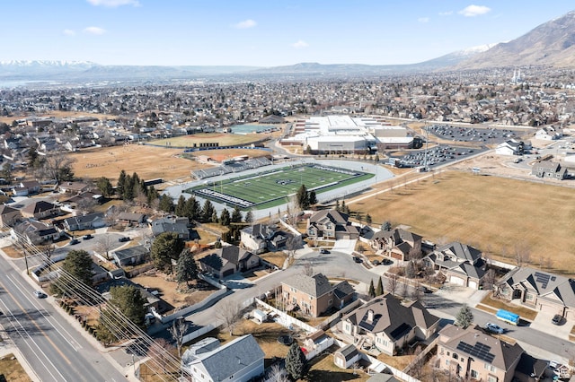 aerial view of property and surrounding area with a mountain backdrop and nearby suburban area