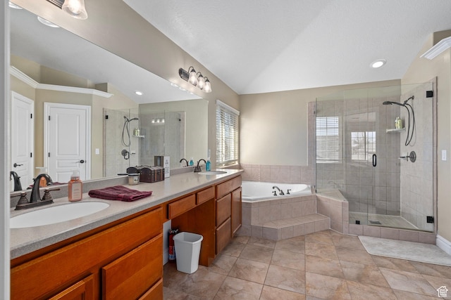 bathroom featuring vaulted ceiling, a garden tub, a shower stall, double vanity, and recessed lighting