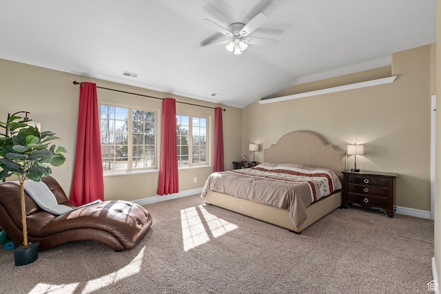 carpeted bedroom with baseboards and lofted ceiling
