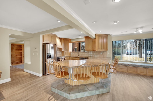 3240 Shadowbrook Dr, Provo, UT 84604 - kitchen with stainless steel fridge with ice dispenser, a breakfast bar, crown molding, light wood-type flooring, and backsplash