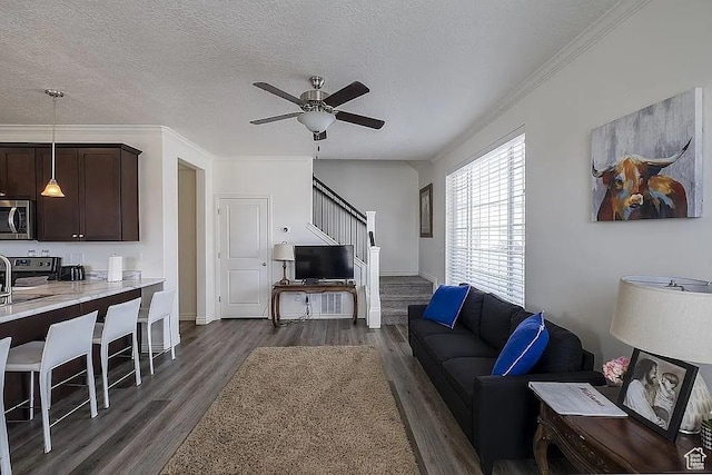 1042 W 500 S, Provo, UT 84601 - living room with dark wood finished floors, a ceiling fan, ornamental molding, stairs, and a textured ceiling