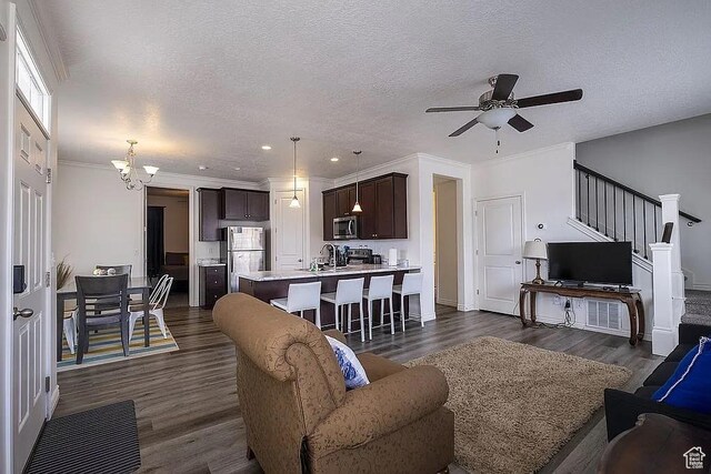 1042 W 500 S, Provo, UT 84601 - living room featuring dark wood-style floors, ornamental molding, stairway, and a textured ceiling