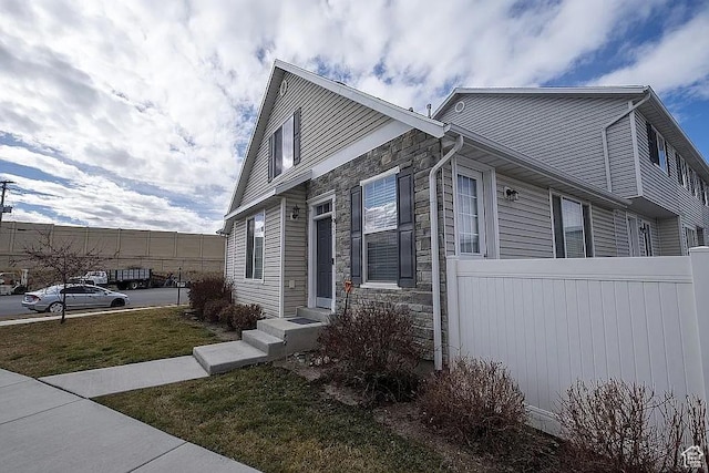 1042 W 500 S, Provo, UT 84601 - view of property exterior with entry steps, stone siding, and fence
