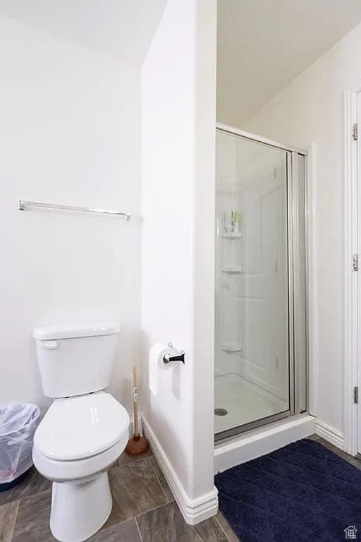 1042 W 500 S, Provo, UT 84601 - bathroom with a stall shower, baseboards, and toilet