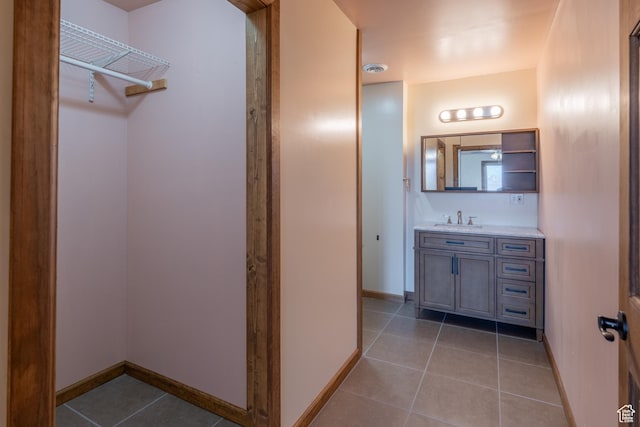 bathroom featuring baseboards, visible vents, vanity, and tile patterned floors