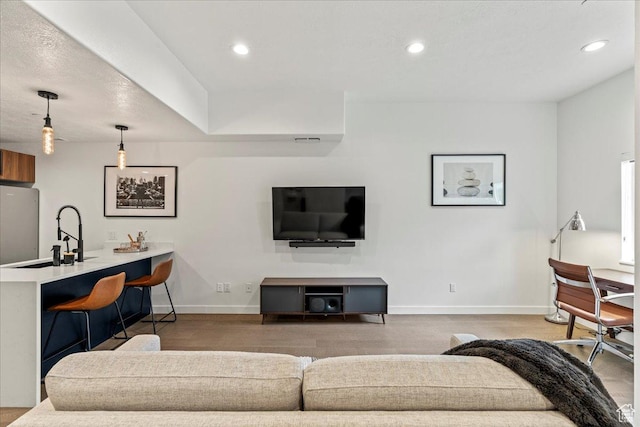 living room featuring recessed lighting and baseboards