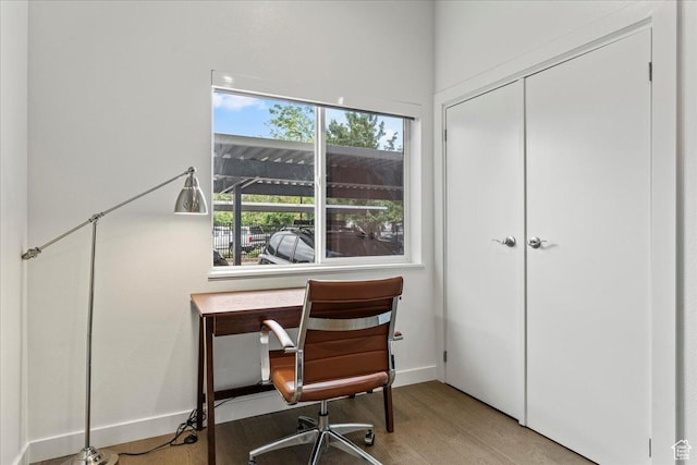 office space with light wood finished floors and baseboards