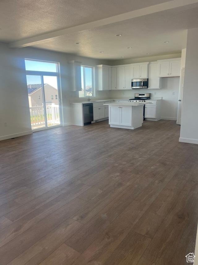 492 W Quartz Rd Unit 8019, Tooele, UT 84074 - kitchen featuring appliances with stainless steel finishes, dark wood finished floors, baseboards, open floor plan, and white cabinetry