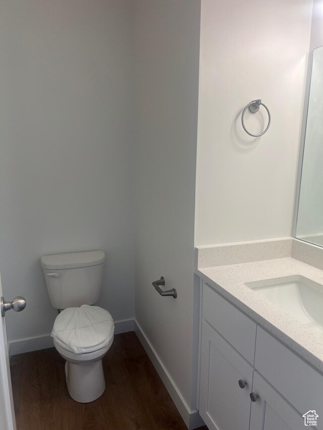 492 W Quartz Rd Unit 8019, Tooele, UT 84074 - half bath featuring toilet, baseboards, wood finished floors, and vanity