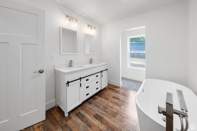 524 N 200 W, Tooele, UT 84074 - bathroom featuring double vanity, a freestanding tub, and wood finished floors