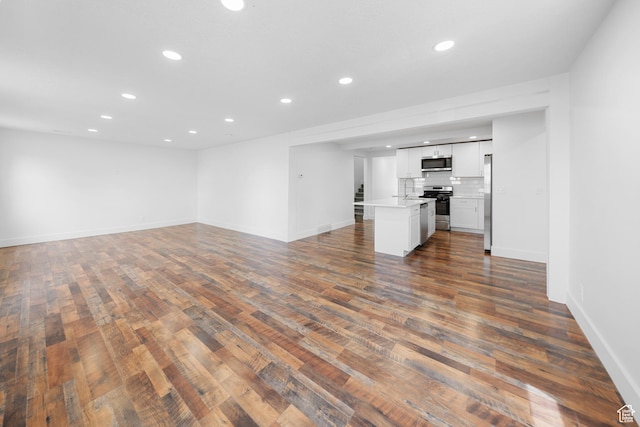 524 N 200 W, Tooele, UT 84074 - unfurnished living room featuring recessed lighting and dark wood-style floors