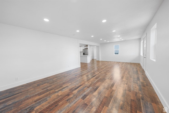 524 N 200 W, Tooele, UT 84074 - unfurnished living room with recessed lighting and dark wood-type flooring