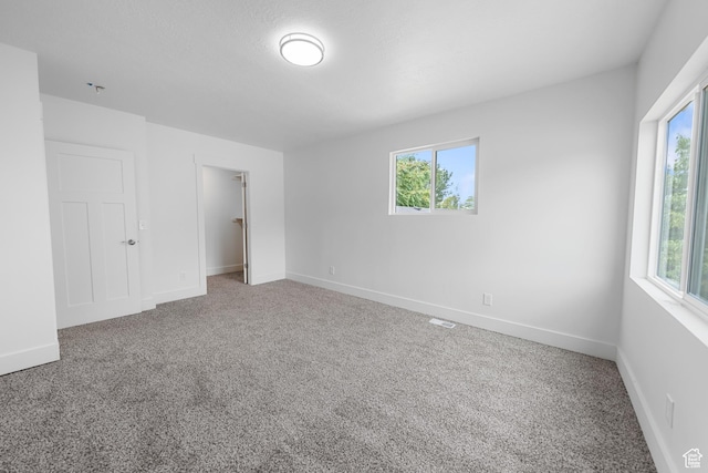 524 N 200 W, Tooele, UT 84074 - unfurnished bedroom featuring carpet floors, a spacious closet, and a closet