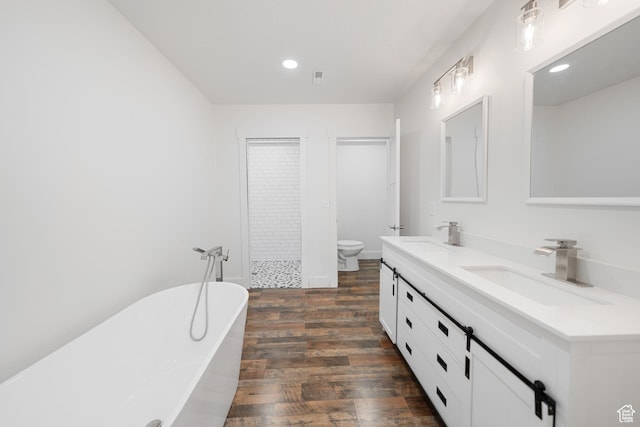 524 N 200 W, Tooele, UT 84074 - bathroom with wood finished floors, double vanity, a freestanding bath, recessed lighting, and a tile shower