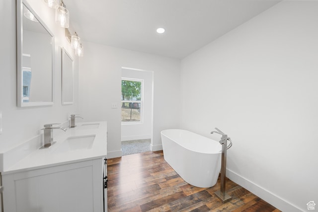 524 N 200 W, Tooele, UT 84074 - full bath featuring a freestanding bath, double vanity, wood finished floors, and recessed lighting