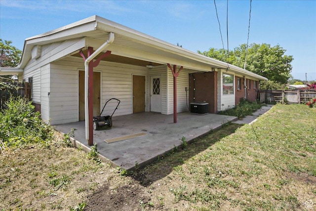 view of front of property with a patio area, fence, and a front lawn