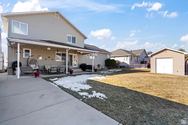 1004 W 4050 S, Riverdale, UT 84405 - rear view of property featuring a detached garage, a lawn, and a patio