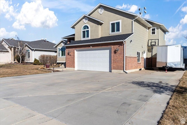 1004 W 4050 S, Riverdale, UT 84405 - view of front facade with a garage, driveway, brick siding, and stucco siding