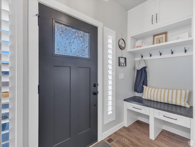 mudroom with dark wood-type flooring and baseboards
