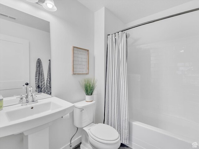 full bathroom with visible vents, a sink, shower / bath combination with curtain, and toilet