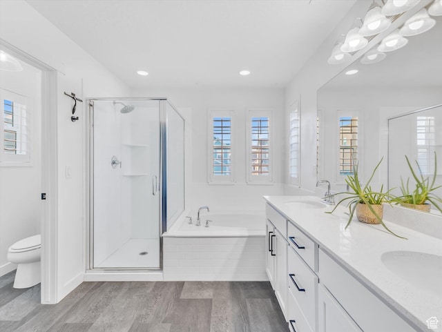 bathroom with a sink, a shower stall, and a bath