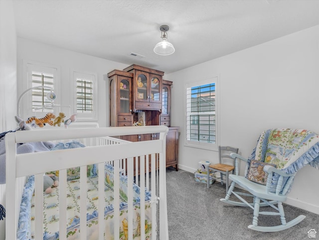 carpeted bedroom with baseboards and visible vents