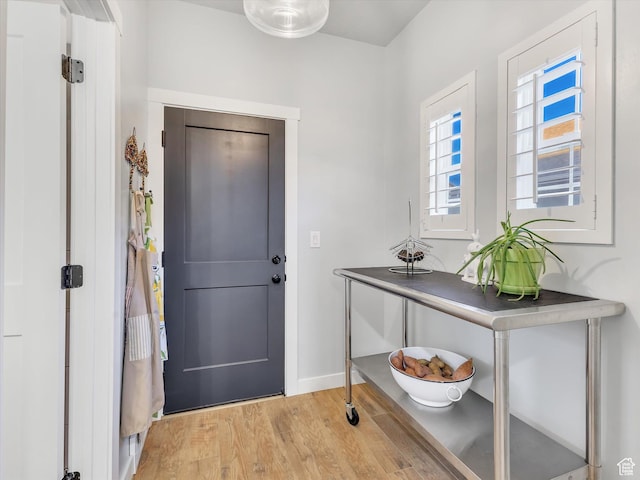entryway featuring baseboards and light wood finished floors
