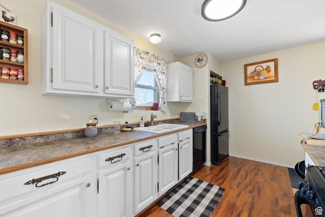 879 E Main St, Mount Pleasant, UT 84647 - kitchen featuring white cabinets, dark countertops, dark wood-type flooring, black appliances, and a sink