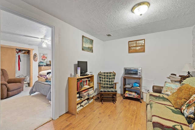 879 E Main St, Mount Pleasant, UT 84647 - living area featuring light wood-type flooring, a toaster, visible vents, and a textured ceiling