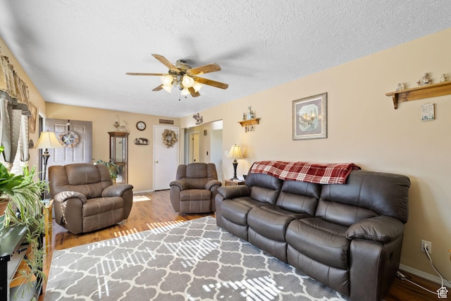 879 E Main St, Mount Pleasant, UT 84647 - living room with a ceiling fan, a textured ceiling, baseboards, and wood finished floors