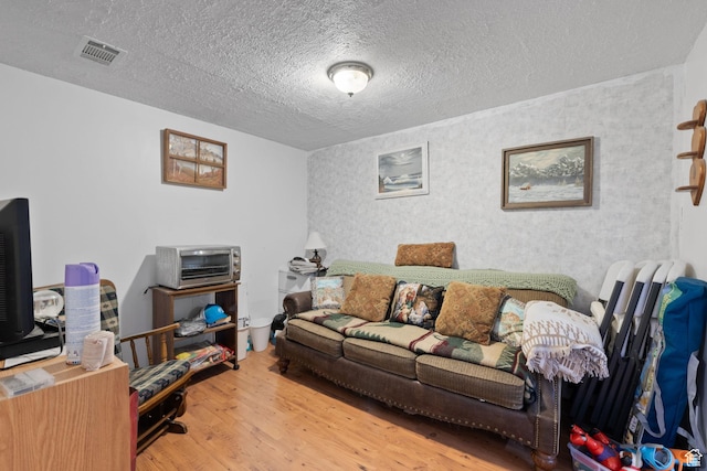 879 E Main St, Mount Pleasant, UT 84647 - living room featuring a toaster, a textured ceiling, visible vents, and wood finished floors