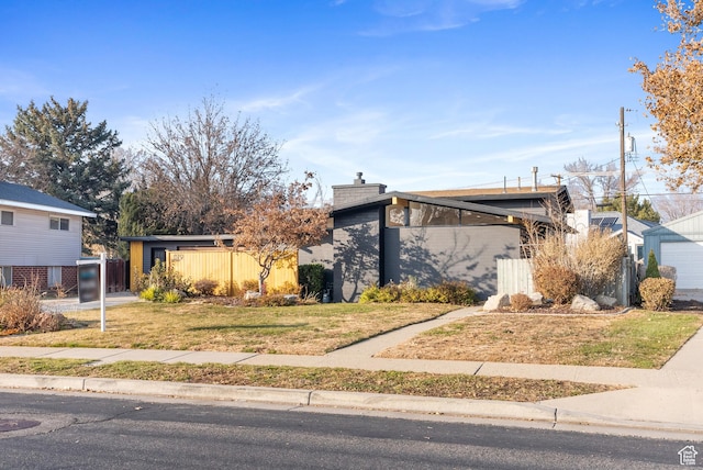 1379 E Sumac Way, Murray, UT 84121 - mid-century home with a chimney, a garage, and a front lawn
