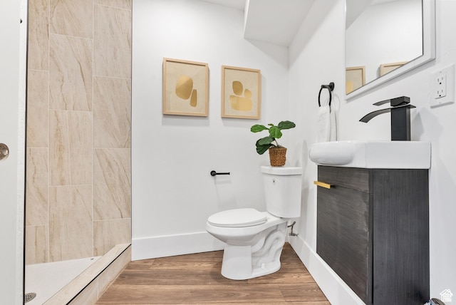 1379 E Sumac Way, Murray, UT 84121 - full bathroom with toilet, vanity, a tile shower, baseboards, and wood finished floors