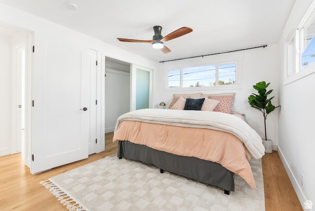 1379 E Sumac Way, Murray, UT 84121 - bedroom with light wood-style flooring, multiple windows, ceiling fan, and baseboards