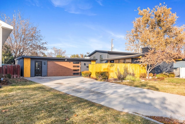 1379 E Sumac Way, Murray, UT 84121 - mid-century modern home with driveway and an attached garage