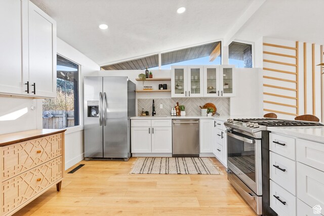 1379 E Sumac Way, Murray, UT 84121 - kitchen with appliances with stainless steel finishes, decorative backsplash, light wood-style flooring, light countertops, and white cabinetry